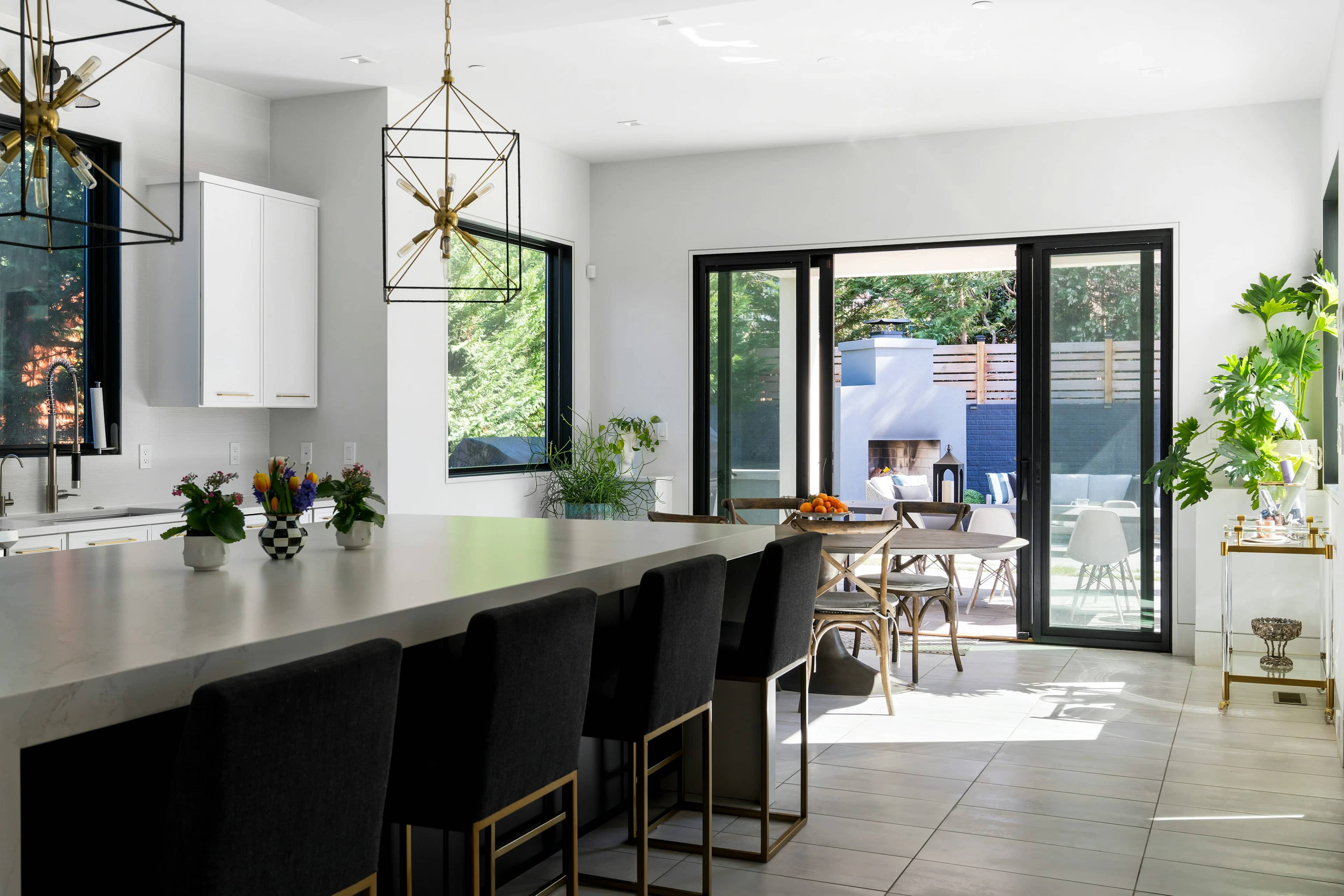 Modern kitchen island opening onto a shaded patio